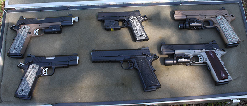Pistols used in evaluation, left to right, top row: Roberts Defense with SureFire XC1, Browning Black Label with Streamlight TLR-6, Colt M45A1 with SureFire X300. Bottom row: Roberts Defense 9mm, STI 9mm, Colt Rail Gun with SureFire X200.