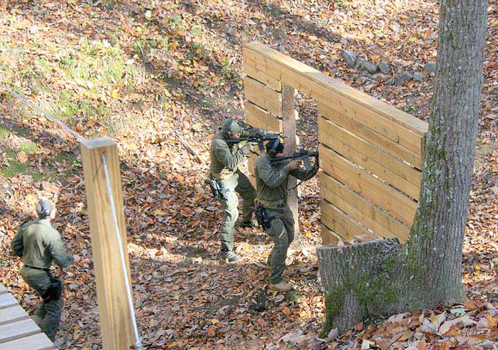 Pair of riflemen neutralizes steel targets from doorway. To maximize cover, shooter on right should have shifted SBR to left shoulder.