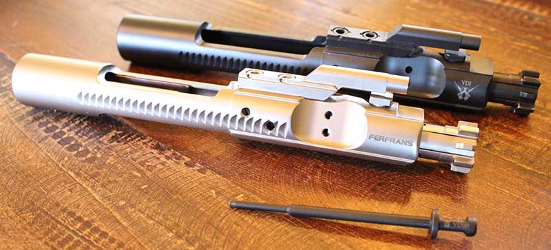 Modern metal coatings and treatments are proving superior to traditional phosphate coatings and chrome lining. Ferfrans Nickel Boron coated bolt and bolt carrier (front) and VooDoo Innovations (VDI) Melonite treated bolt/bolt carrier (rear). On VDI Melonited firing pin, carbon build-up just wipes off. It needs no scraping or wire brushing.