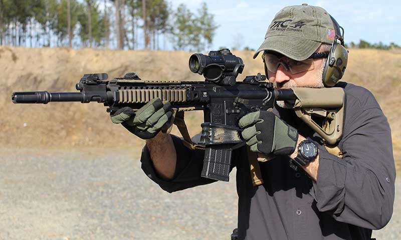 Technology needed to improve the M4/M4A1 series of carbines is already in use. Although it’s a piston gun, author’s AR has all the upgrades he recommends: mid-length gas system, better flash hider, grip, and Melonite-treated barrel, firing pin, bolt, and bolt carrier.  