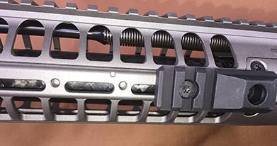 Threaded holes in handguard accept accessory rails, such as QD sling mount rail shown here.