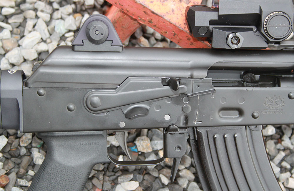 Krebs Mk VI safety lever lets trigger finger manipulate safety selector without changing firing grip on the weapon. Notch can be used as bolt hold-open device.