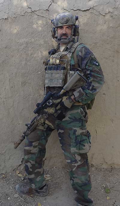 Author in Afghanistan, 2015. M4A1 outfitted with Trijicon VCOG, BCM GUNFIGHTER grip, Ark Defense buttstock, Magpul AFG, offset mini-red dot, and Arredondo extended mag well.