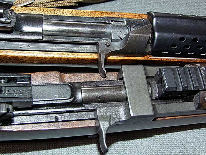Chiappa M1-9 (bottom) lacks bolt hold open found on the original, which also utilizes a rotating bolt, while M1-9 is straight blowback.