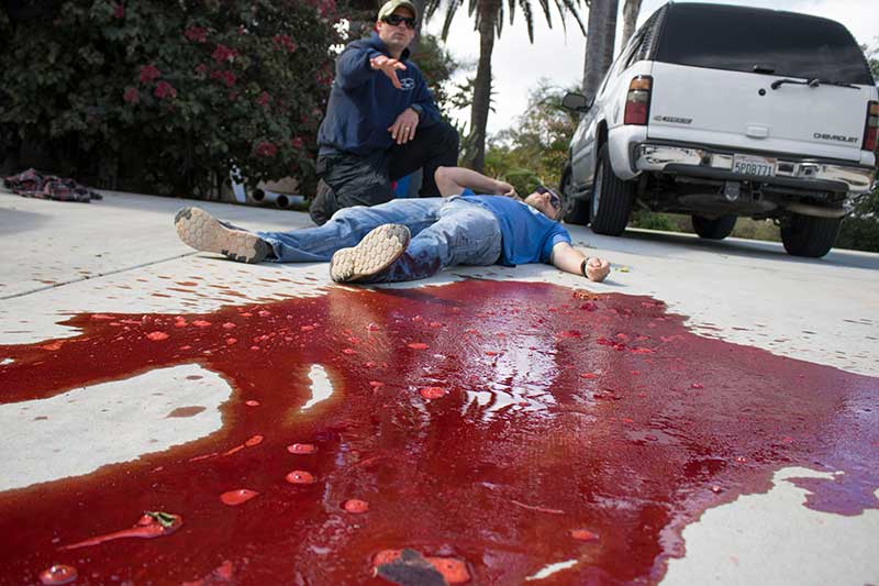 Stoehner demonstrates approximate volume of blood that may be lost, to help students make rapid trauma assessments during mass-casualty events.