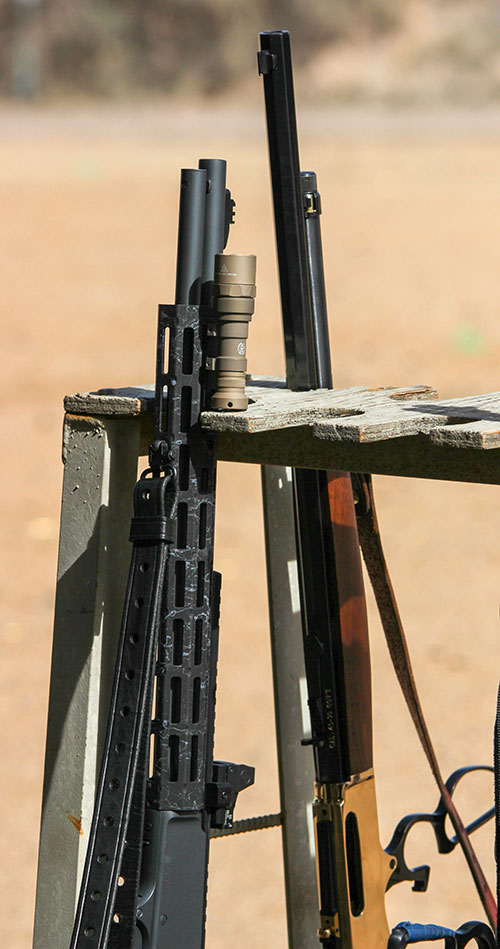 Fully tricked-out modern defensive lever-action rifle sits next to its more traditional counterpart.