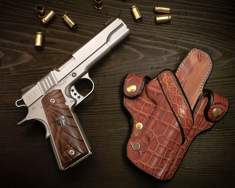 Sights are Novak and slide boasts unique Trinity Stripes gripping serrations. Exotic animal skin holster is from Sam Andrews Custom Leather.