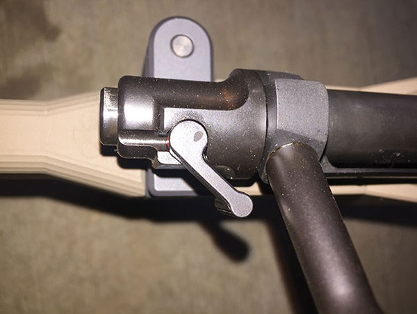 Rifle uses Model 70-type three-position wing safety. Forward position fire, center position bolt can be worked but not fired. Rear position bolt is locked.