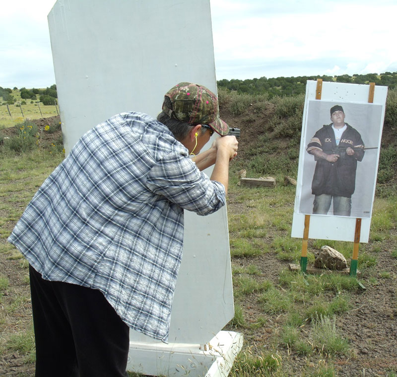 Student practices firing from around a barricade to lessen exposure to unknown assailant, a necessary element depending on the amount of cover and concealment available.