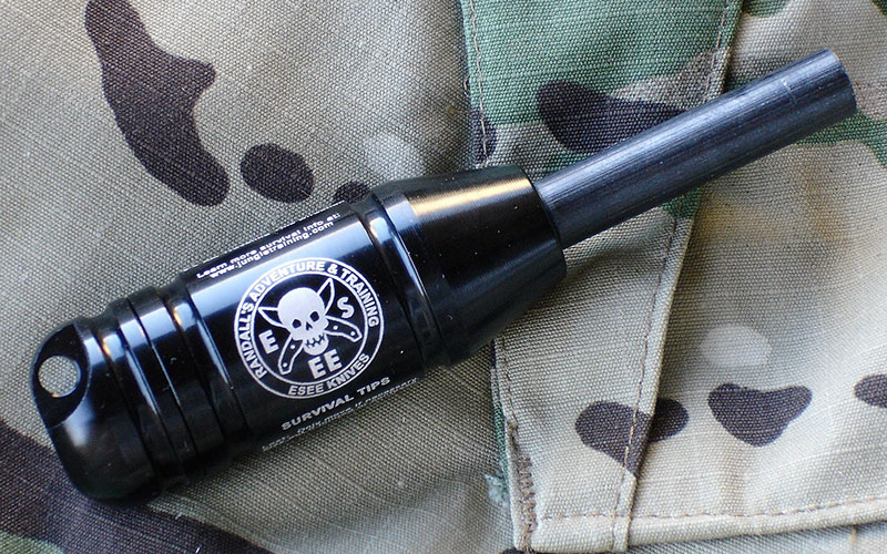 ESEE Fire Kit is a “last-ditch” fire starter (ferro rod) and mini survival kit container that includes a 20mm button compass in the cap and survival tips printed on the body. Watertight capsule has plenty of storage space for survival essentials.