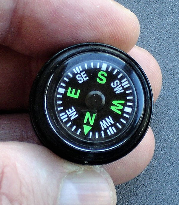 20mm Grade A button compass in cap of ESEE Fire Kit has luminous dial with large, easy-to-read markings.