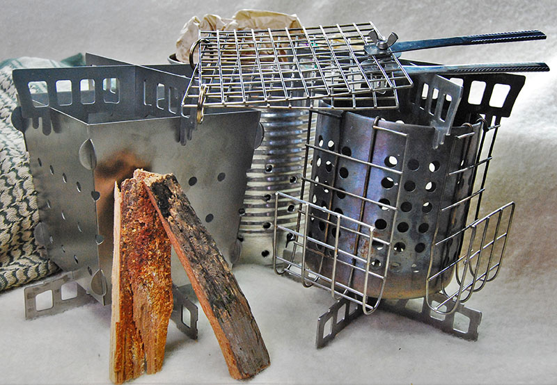 Siege Stove has numerous uses and accessories. Brackets come in titanium and stainless steel and each can be used with different container types. Even wide cans with a few well-placed holes can be adapted to fit the bracket system.