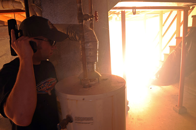 Flashbang deflagrates in basement of house where Rapid City, South Dakota police officer Ryan McCandless poses as armed perpetrator for special weapons and tactics exercise. Photo: U.S. Air Force photo by Senior Airman Marc I. Lane / Released