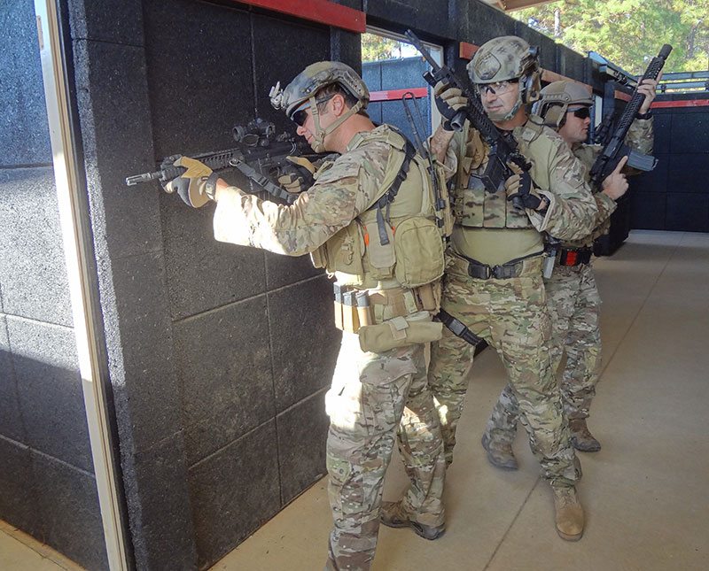 Number one man utilizes stand-off as he pies off the door and hunts for targets. Doing so limits his exposure and provides some cover before he commits to making entry.