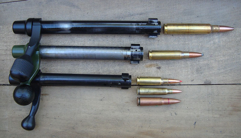 Mini-Action’s short bolt (bottom) offers shorter, faster bolt stroke. Combined with resulting smaller action, a handy and compact rifle results. Remington long- and short-action bolts on top.