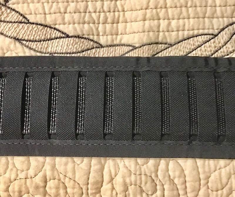Wilder Tactical Minimalist Belt Pad uses vertical slots instead of horizontal MOLLE slots, making use of conventional holsters and pouches possible.