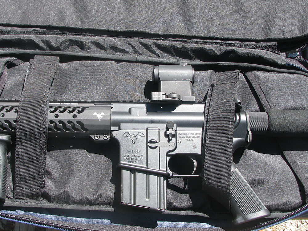 Velcro straps hold gun, magazine, and optic securely in SneakyBag.