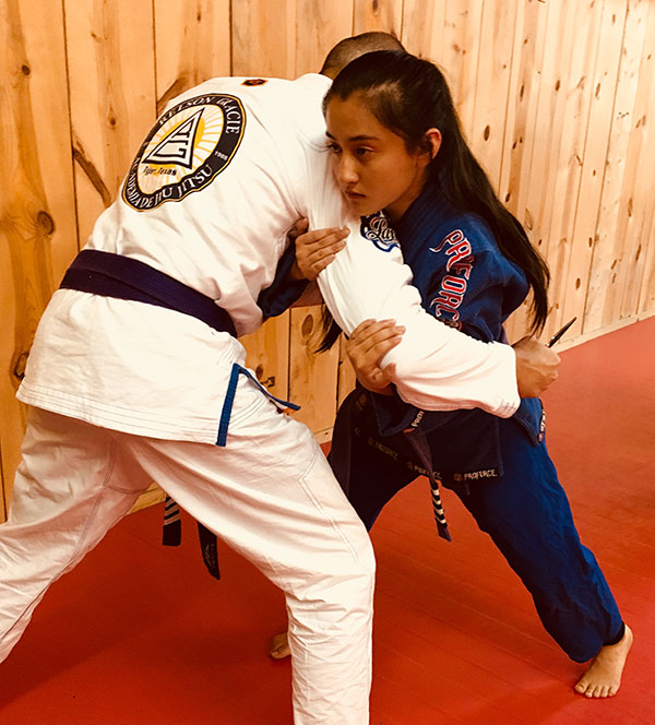 Tala Arthur, Judo Black Belt and Relson Gracie Jiu Jitsu 4-stripe purple belt, works through immediate-action drills with author. Tala has intercepted author's lunge using Red Zone Dive-and-Drive technique prior to establishing two-handed grip known as the Handcuff on his wrist.