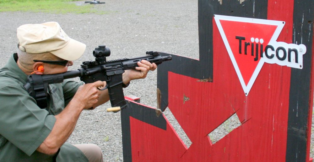 USMC Colonel (Retired) Frank Martello, VP at Trijicon, spanks steel at 100 yards with highly accurate and rugged MRO red-dot sight.