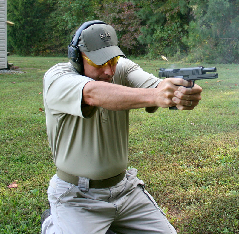 Former FAM Ken Trice drops to double kneeling position and hammers target with multiple rounds. Recoil’s absorbing weight facilitated low split times for double taps and hammers. Little effort was required to bring muzzle back down from muzzle rise.