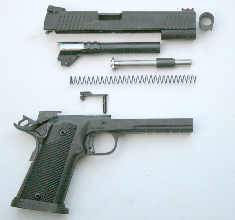 TUFSHC field stripped, revealing barrel bushing, reverse plug, steel guide rod, recoil spring, and slide stop. Barrel with swinging link is 4140 carbon steel with 1:16 twist.