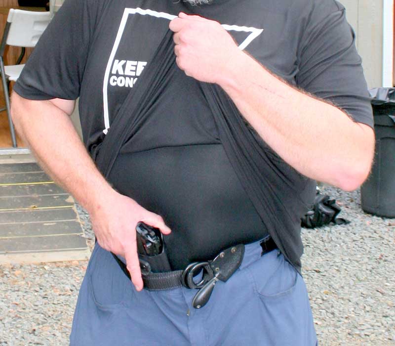 Keepers demos grip on pistol carried AIWB. Support hand lifts cover garment as high as possible to chin. Undergarment is smooth and reduces drag during draw.