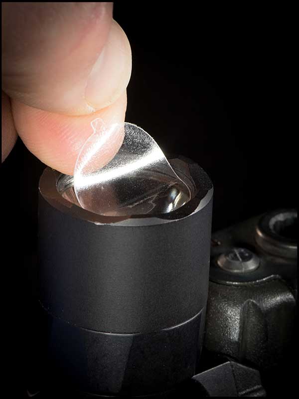 CLENS is a mild adhesive-backed, heat-resistant clear polymer circle that protects the lens from carbon and other debris that can build up from the use of lights during firearms training.