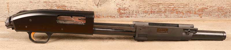 Beating heart of Mossberg FLEX TLS system is an otherwise unadorned slide-action shotgun frame.