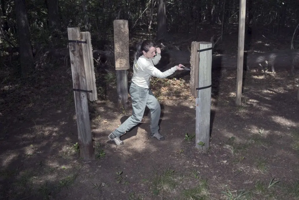 woman doing self-defense training with a knife