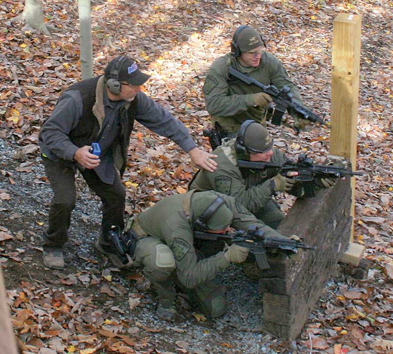 Clemente points out long-range targets to three-man fire team situated along high ground’s military crest.