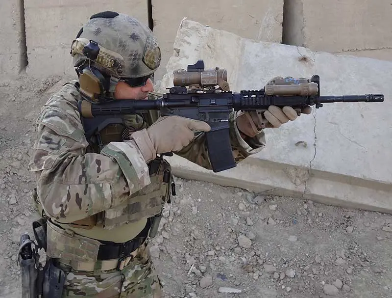 Author using general-issue M4 equipped with then-current SOPMOD Block II items in 2015. Except for a heavier barrel, the carbine itself has remained almost unchanged since its first issue in the late 1990s.