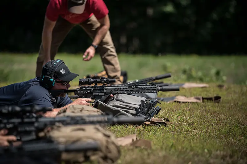 Firing SIG MCX Virtus 5.56mm prone, pack supported. Rifle proved to be one MOA or better performer.