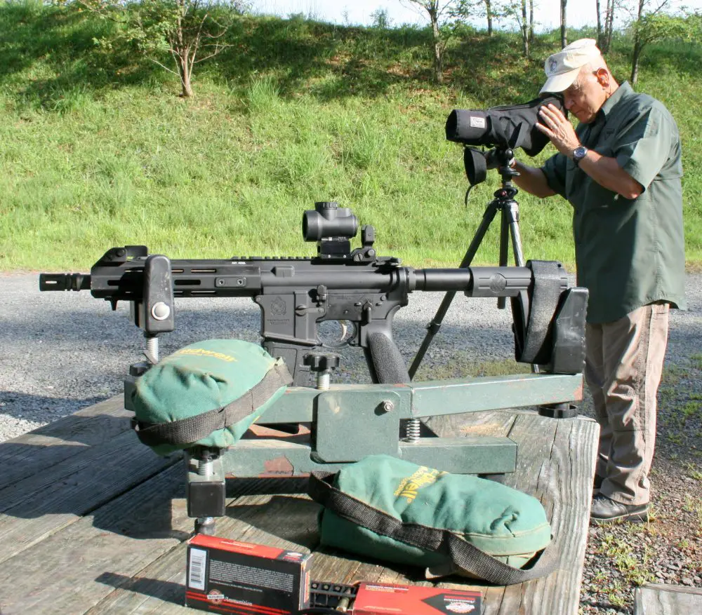 Frank Martello of Trijicon checks SAINT group. Groups were fired with Lead Sled and Trijicon MRO. Black Hills Ammo was used to establish zero and accuracy baseline.