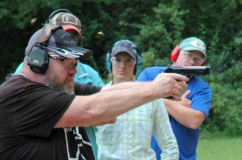 Spencer Keepers fires fast pair at target. Note control over recoil. Keepers emphasizes very strong grip.