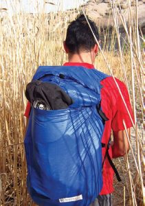 Author-wearing-bright-red-shirt-and-blue-pack-that-contrast-with-Arizona-desert