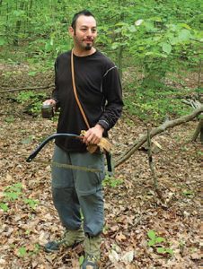 Author-with-Fiskars-21-inch-Bow-Saw-and-leather-work-gloves-he-used-to-build-a-semi-permanent-camp