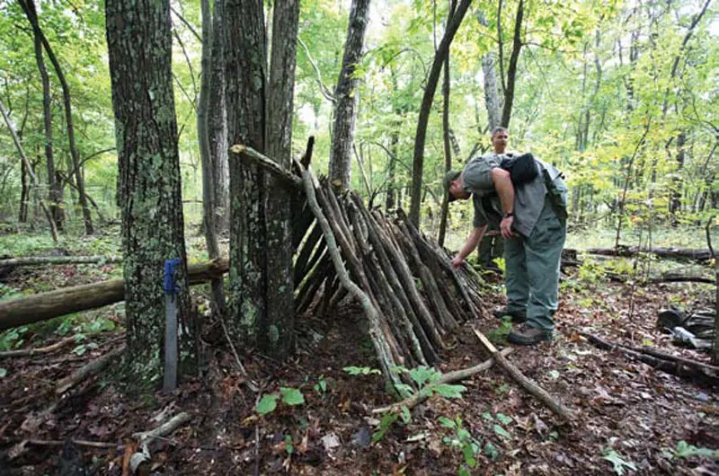 All-it-takes-to-build-the-frame-of-a-classic-debris-hut-is-a-simple-ridge-pole-with-dead-wood-stacked-against-it--