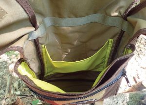 Besides-the-main-pocket,-the-Haversack-has-a-colored-pocket-that-can-store-a-water-bladder-or-maps,-a-medium-pocket,-and-a-zippered-outer-pocket