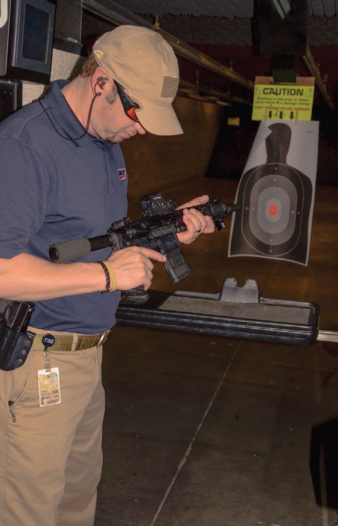 Jason-Brendon,-Sales-Manager-of-C2-Tactical,-examines-San-Tan-Tactical-.300-BLK-PDW-Pistol