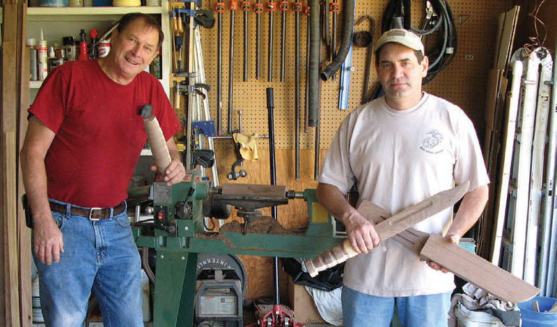 Lt.-Col.-Skaggs-(left)-holds-KA-BAR-grip-that-he-just-turned-on-the-lathe-in-the-background