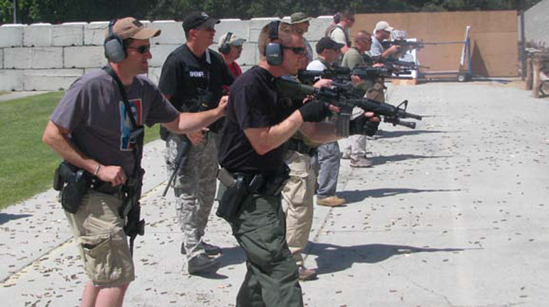 Officers-practice-aggressing-toward-targets,-firing-their-carbines-from-a-sternum-hold