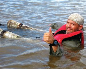 On-Amazon-River,-survival-student-shows-proper-way-to-sit-in-one-man-raft,-giving-him-optimal-control