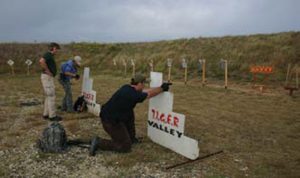 Shooters-engage-metal-silhouettes-with-pistol