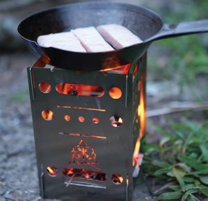 TOPS-Stove-fries-food-with-wood-as-main-fuel,-using-fast-rising-heat-for-speedy-cook-times