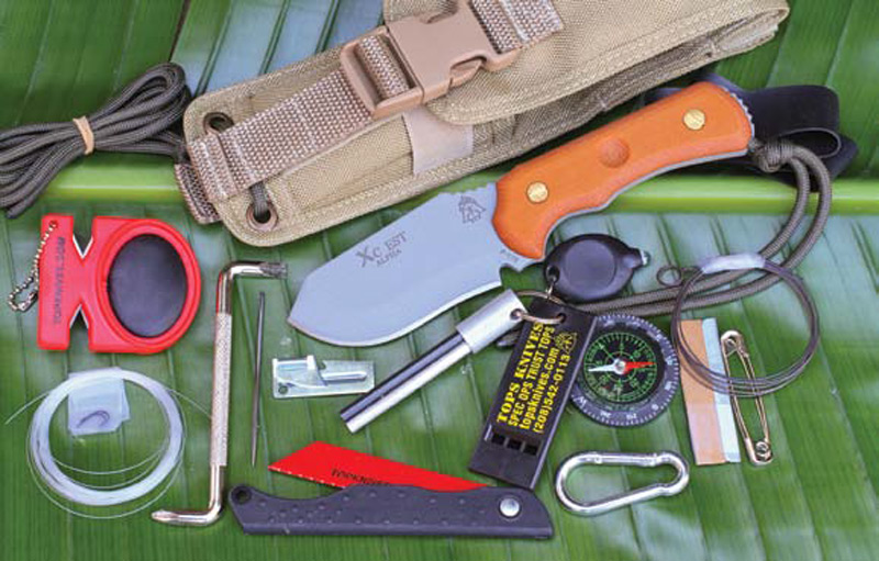 TOPS-XcEST-Alpha-with-entire-contents-and-tan-ballistic-nylon-sheath—a-one-kit-doesall-survival-system