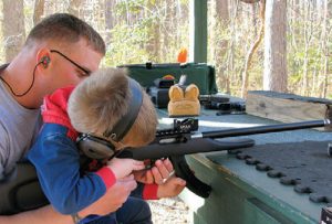 Team-member’s-three-year-old-son-evaluates-MR-rifle-with-See-All-Open-Sight