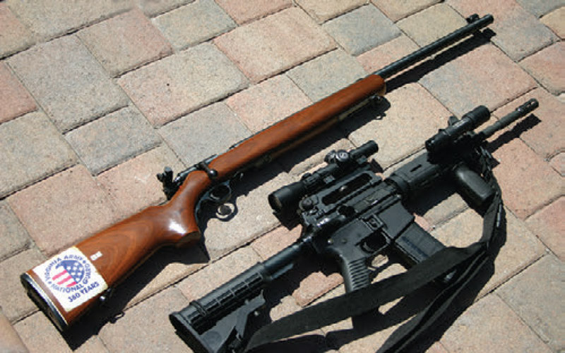 Two-extremes-Precision-Mossberg-.22-bolt-action-target-rifle-(top)-and-AR-15-with-BCM-upper
