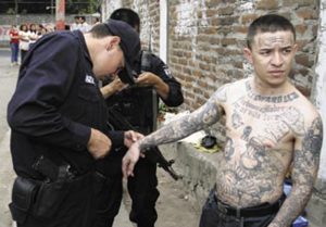 UTO-Team-members-inspect-tattoos-on-a-gang-member-from-Arlington,-VA