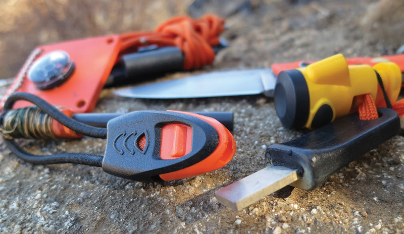 Whistle-attached-to-firesteel-and-striker-attached-to-light-on-knife-lanyard