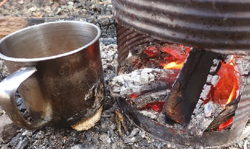 Coffee-cups-and-some-food-can-be-warmed-as-stove-dies-down-due-to-radiant-heat-and-glowing-coals
